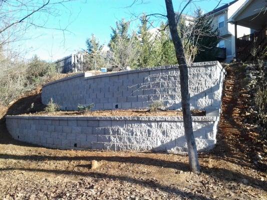 Beautiful Gravity Stone wall block was installed. Now the home owners back yard has more back yard space as well as landscaping.