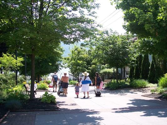 Families enjoy the broad sidewalks in Lake George Village