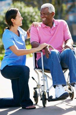 The caregiver is about to transfer the client from the wheelchair to the car and is ensuring him that she'll transfer him safely.