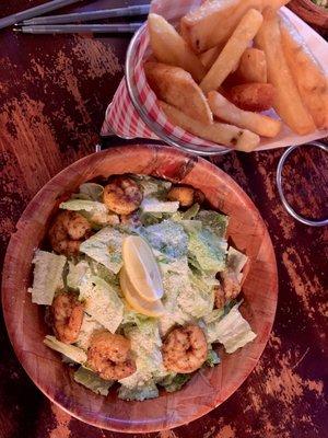 Shrimp Caesar salad with a side of steak Cut fries