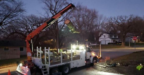 One of our knuckleboom cranes loading out logs.