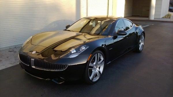 Sleek Fisker Karma outside the garage area