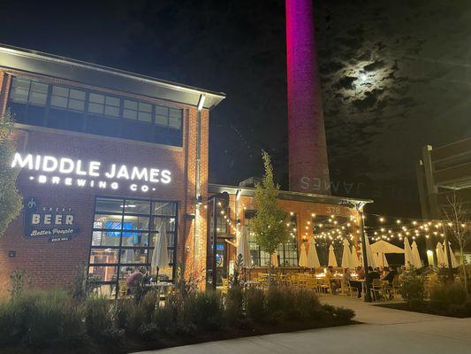 Middle James Brewing garage door and awesome patio at night. The lights and fire pit are wonderful!