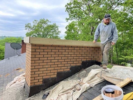 Forming a new crown on this chimney rebuild.