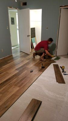 The handy Brit handyman doing a great job putting down my luxury vinyl plank in my condo