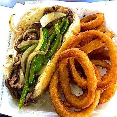 Sliced ribeye steak sandwich with onion rings. Served with hot au jus for dipping.