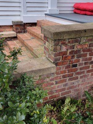 Brick spalling and mortar deterioration on historic home.