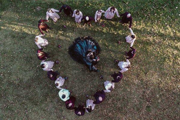 A bride surrounded by her guests, taken with a drone