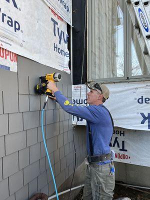 Installing siding.