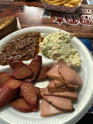 Hot links, bologna and spicy beans and potato salad