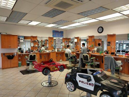 Inside the barber shop. They've got those car chairs for kids.