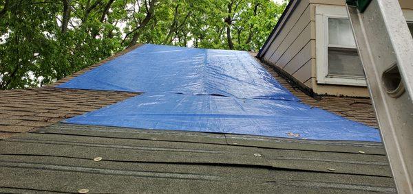 We placed a tarp on a roof to keep it safe from more damage and possibly damaging the inside if it hasn't already.