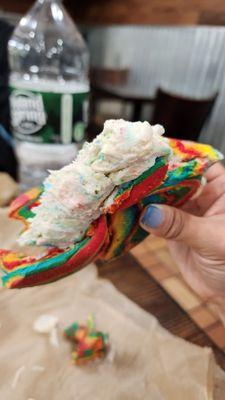 Birthday cake cream cheese on a Rainbow bagel. Toasted