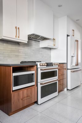 After. Brass tones and wood grains bring warmth to this contemporary kitchen. Swoon with us! #kitchendesign #kitchencabinets #kitchenremodel