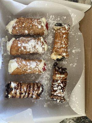 Traditional cannolis, espresso filling with chocolate chips, chocolate drizzle, caramel drizzle