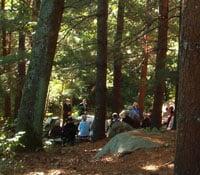 In July and August, the 8 am Sunday worship is outdoors in the Chapel in the Pines.