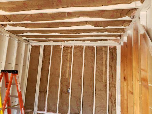 Installing insulation before wallboard