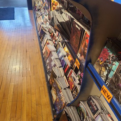 New release shelf over filled with damaged books