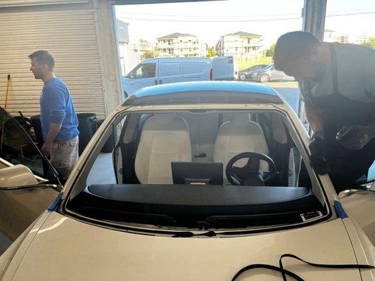 Tesla windshield replacement and recalibration by Auto Glass Force. We specialize in all Tesla models and glasses.