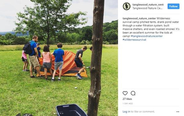 Summer campers practice setting up tents and other outdoor skills.