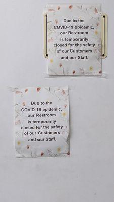 Signs on bathroom that they are closed due to Covid.