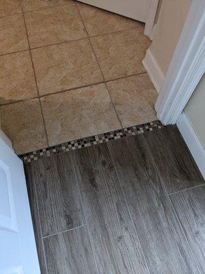 They suggested the glass tile shown for a transition from our old hallway tile to the new wood-look tile.