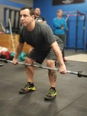 Coach Mike cleaning up his barbell movements