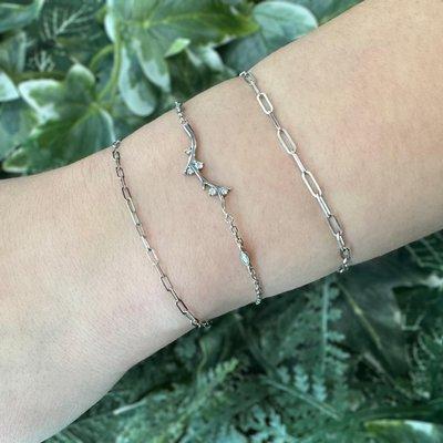 Permanent claspless bracelets. Made of 14k white gold with moissanite accents.