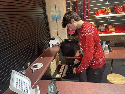 Josh Shum working the register