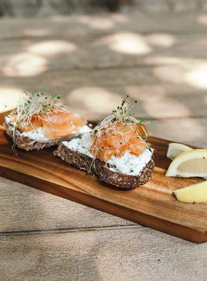 Smoked Scotish salmon on country bread or croissant with ricotta dill, sprouts and lemon.