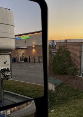 Store front seen through the truck mirror