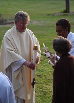 Sharing the flame from the paschal candle.