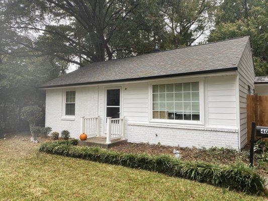 New concrete siding with black gutters