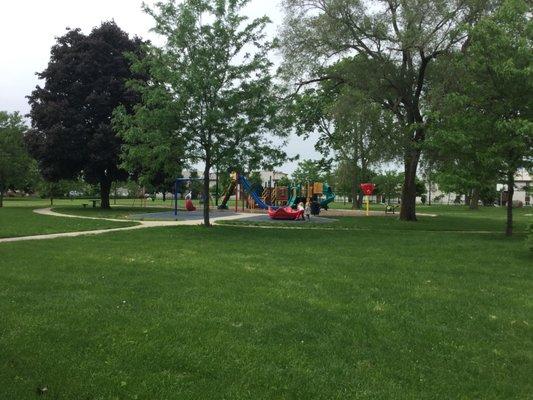 Playground had baby swings, two regular swings, and one accessible swing. A big plastic merry go round, 3 slides, a climbing wall, & “ship.”