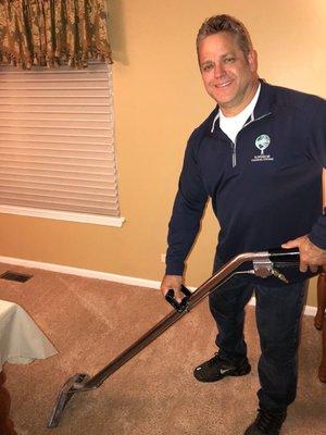 The owner cleaning carpets