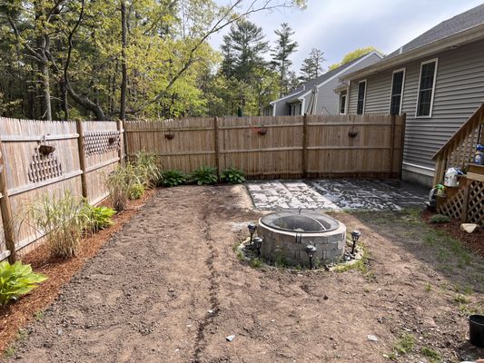 A small back yard makeover. New plantings, mulch, 11x15 patio and new lawn