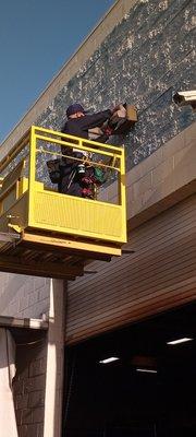 Shop maintenance, halogen light bulb replacement, industrial building, boom lift, electrical services.