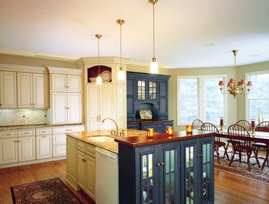 Beautiful traditional white kitchen with blue furniture accents.