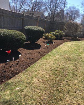 Trimmed bushes and a new mulch bed.