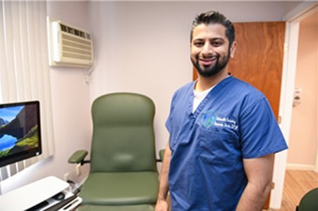 Davinder Bhela, DPM in an exam room at Hicksville Podiatry