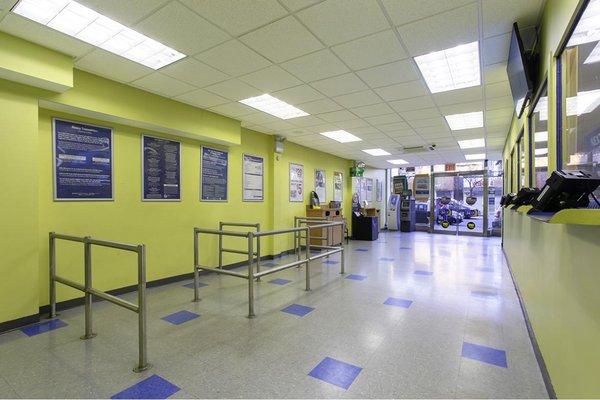 Customer waiting area and teller windows inside PAYOMATIC store located at 11 East Gunhill Road Bronx, NY 10467