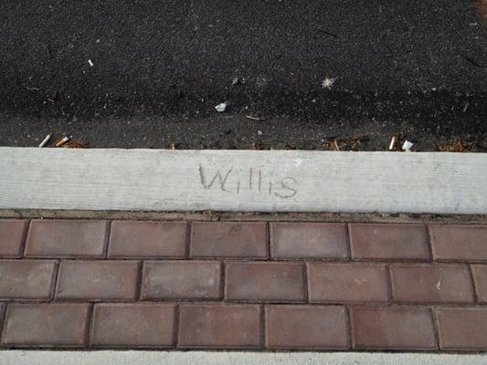 Someone carves their name in front of Genuine Tobacco.