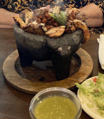 Molcajete chignon volcanic stone filled with meats cool