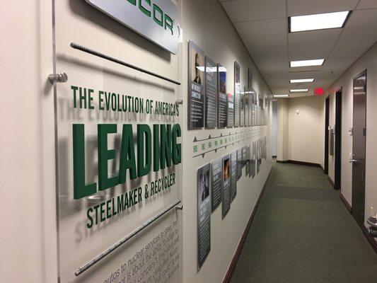 Acrylic panel and print graphics for Nucor timeline in their corporate office.