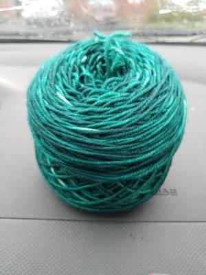 some green hand-dyed whimsical colors yarn.