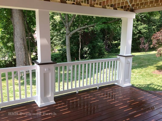 Vinyl deck with recessed columns by Wolf Decking.