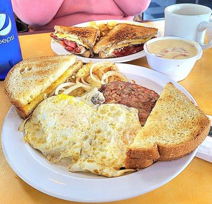 Front, 2 eggs over medium, corned beef hash, hash browns,  toast and a side of cream chipped beef. Back, BLT with egg on wheat bread.