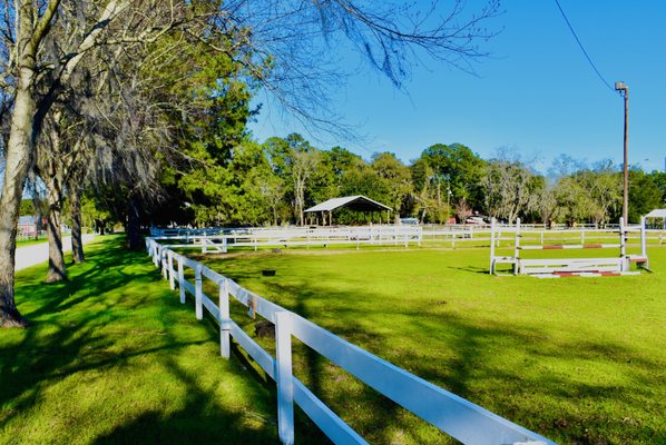 beautifully manicured paddocks where you can find horse grazing, riding lessons being taught, or pony rides