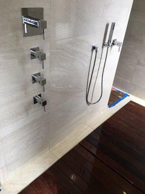 Custom shower with multiple controls.