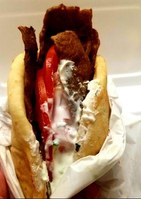 Fantastic Gyro with yogurt, tomatoes, red onions and savory meet. So delicious